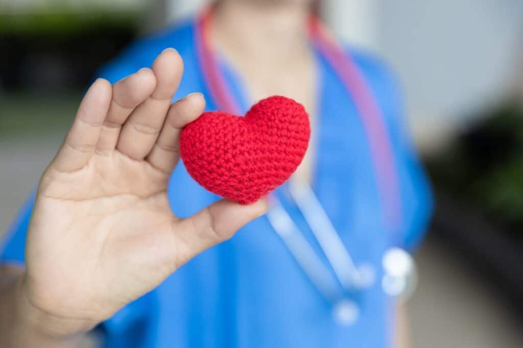 nurser doctor hand showing heart sign for healthcare protect share care with love concept