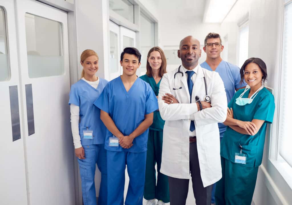 Portrait Of Multi-Cultural Medical Team Standing In Hospital Corridor