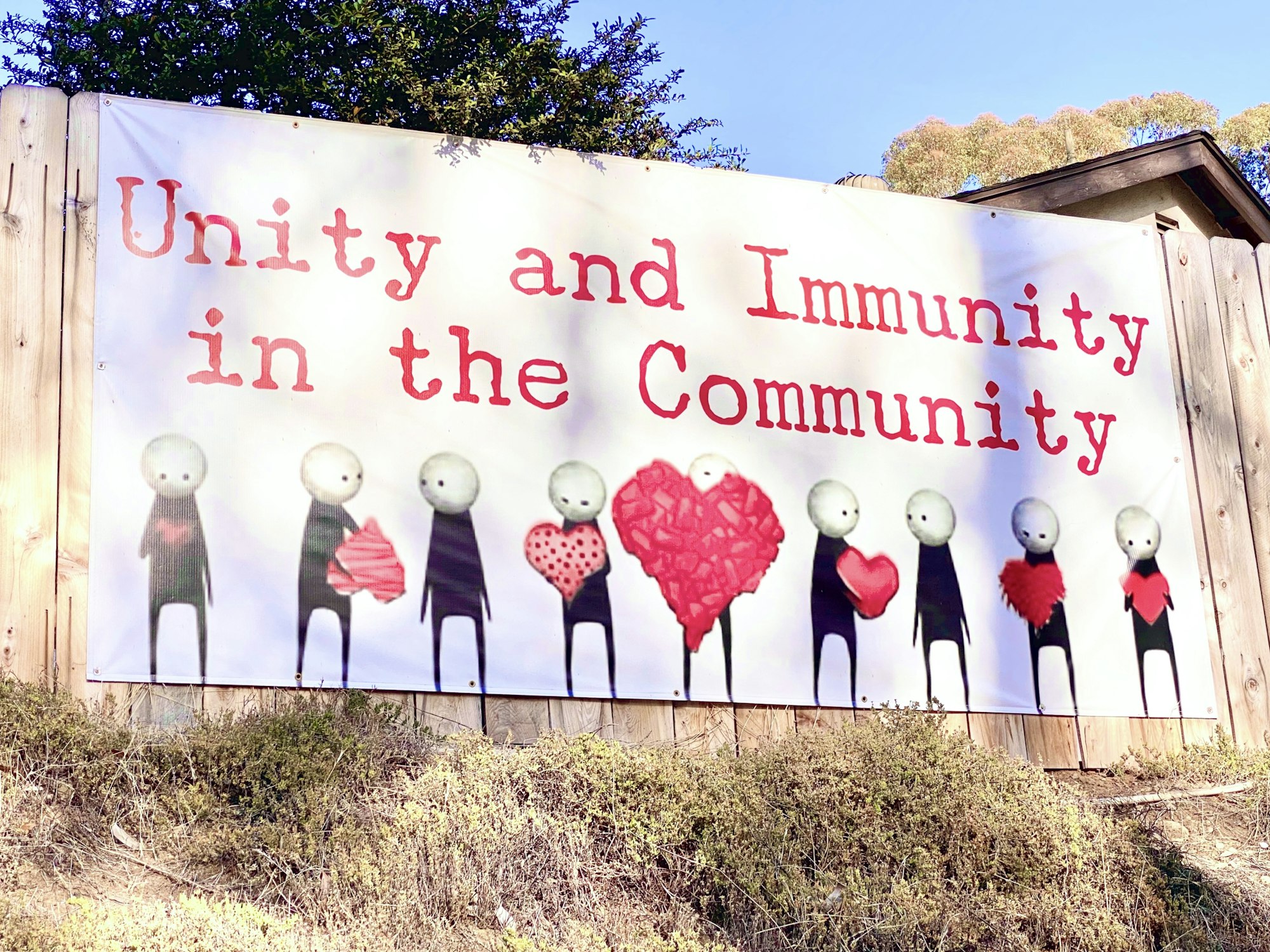 Authentic real community banner sign calling for unity and immunity in the community